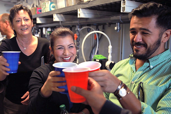 With a toast and a drink of reclaimed water, visitors from the California legislature, governor's office, and state water board celebrate UCLA engineering professor Yoram Cohen's demonstration project using reverse-osmosis to clean contaminated water in California's Central Valley. Photo by John Vande Wege