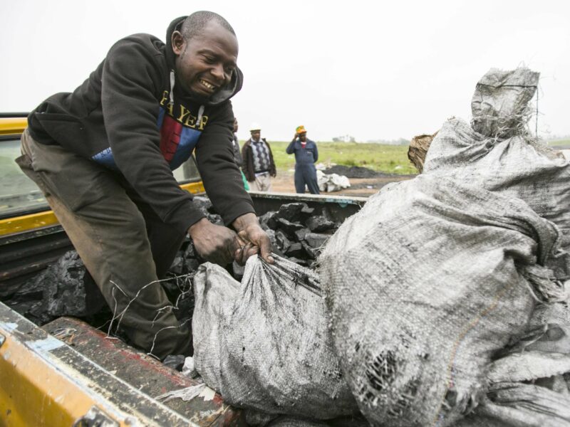 Man loading coal on truck from Emmy-winning episode.