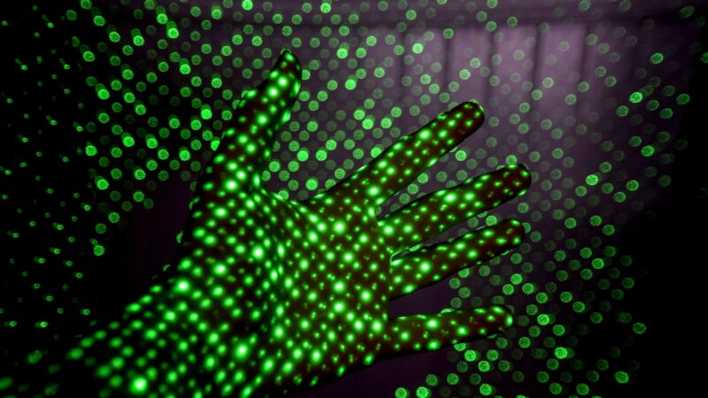 abstract image of green pixels projected on a hand