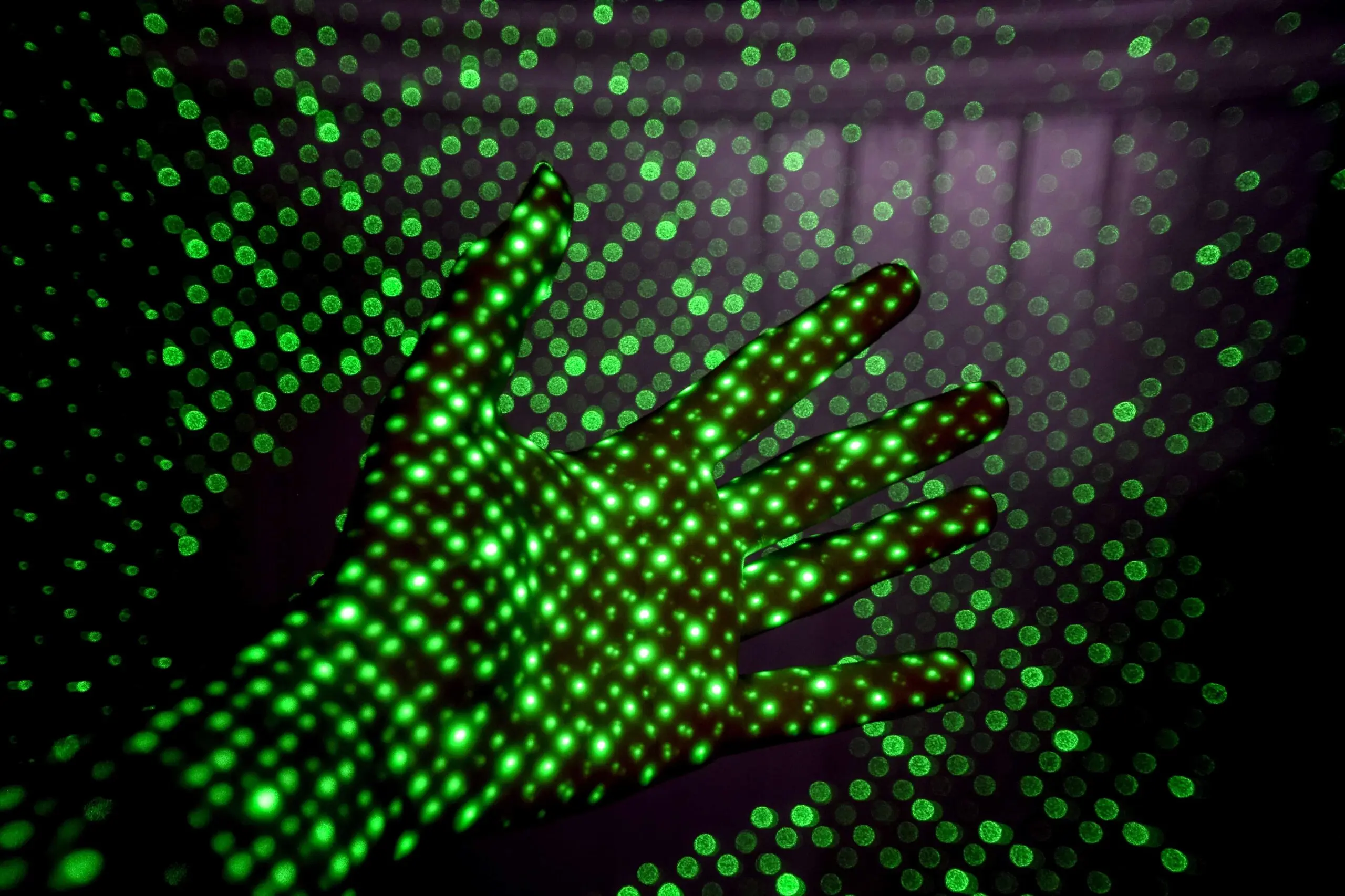 abstract image of green pixels projected on a hand