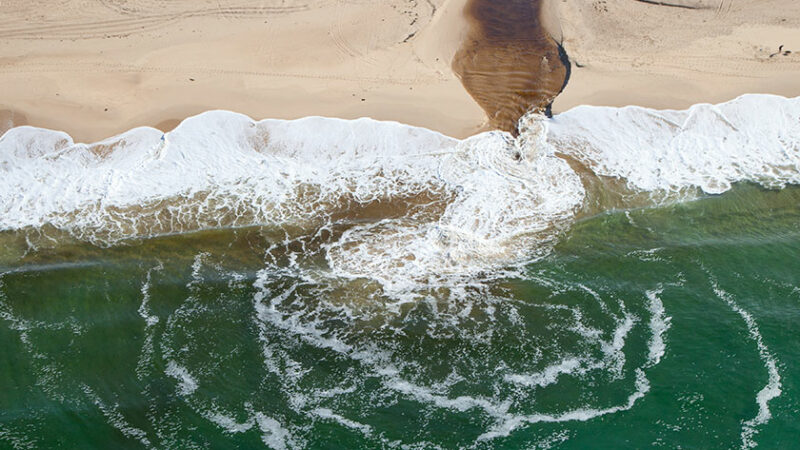 Sewage draining into ocean coast