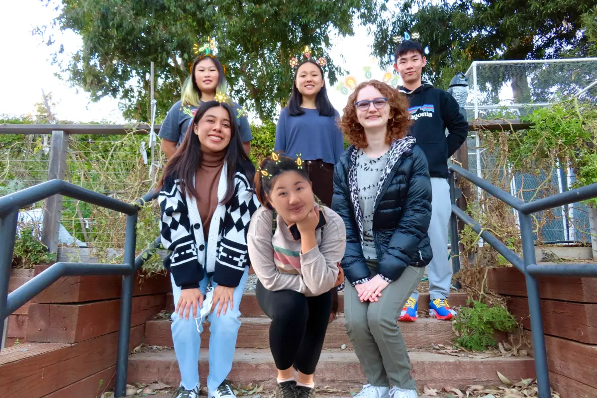 Six students in a garden.