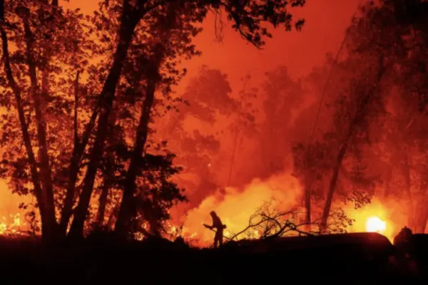 A firefighter douses flames as they push towards homes during the Creek fire in the Cascadel Woods area of unincorporated Madera County, California on September 7, 2020 | Josh Edelson