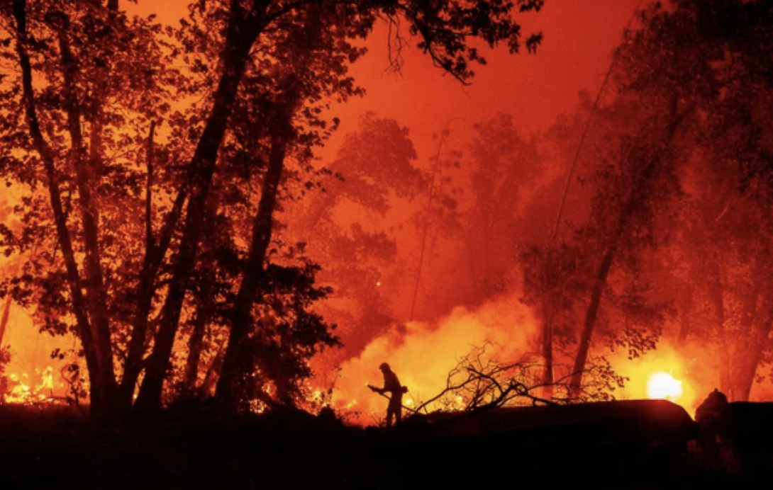 A firefighter douses flames as they push towards homes during the Creek fire in the Cascadel Woods area of unincorporated Madera County, California on September 7, 2020 | Josh Edelson