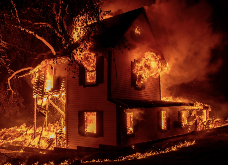 A home burns as the Dixie fire jumps Highway 395 south of Janesville, CA Aug. 16, 2021. (AP Photo/Ethan Swope, File)