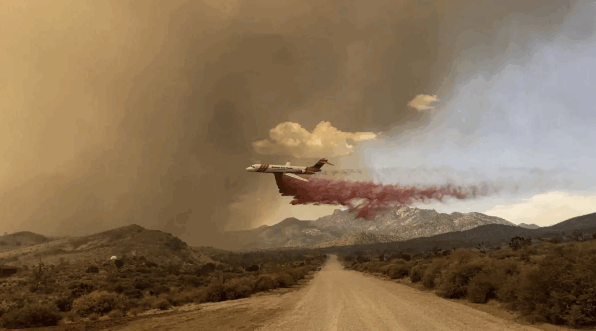 An air tanker drops fire retardant over the York fire in the Mojave National Preserve on Saturday. | R. Almendinger, National Park Service
