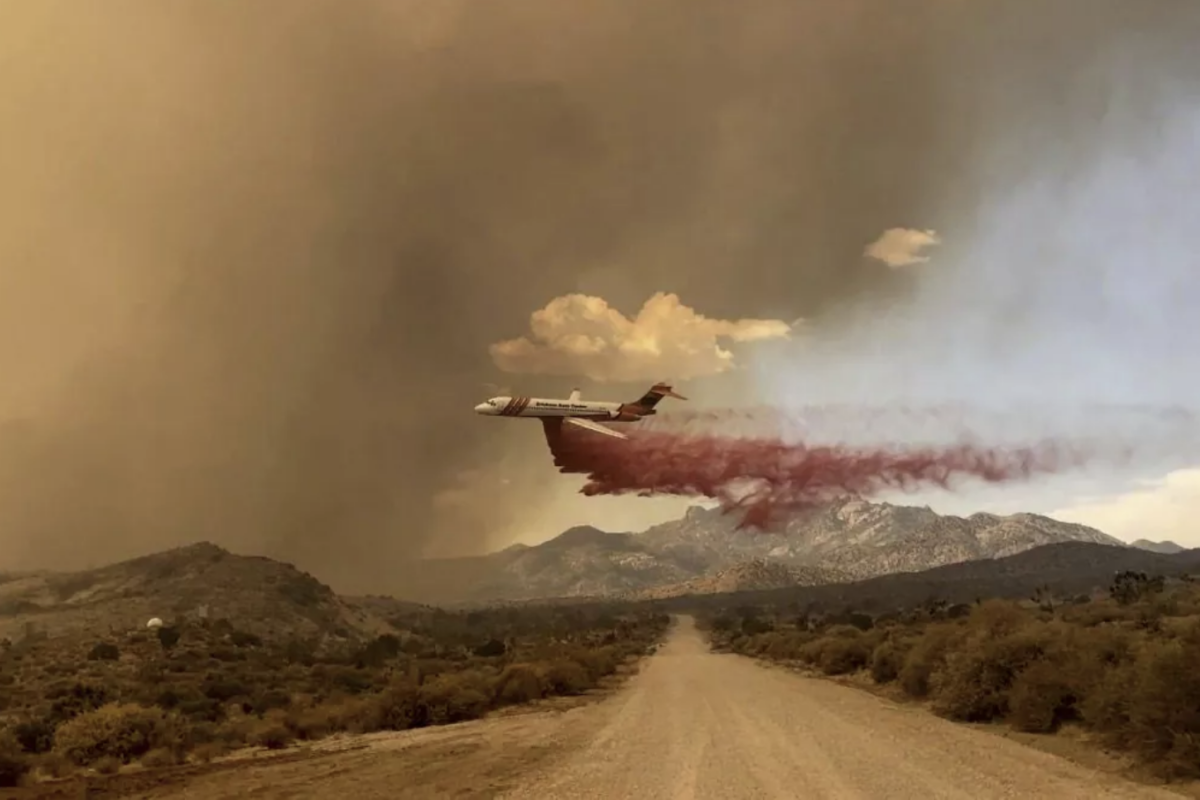 An air tanker drops fire retardant over the York fire in the Mojave National Preserve on Saturday. | R. Almendinger, National Park Service