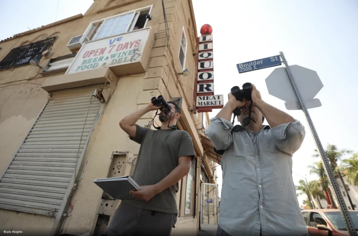 Christian Benitez and Eric M Wood stood outside a corner liquor store searching for birds. Genaro Melina, LA Times