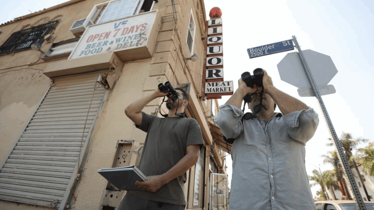 Christian Benitez and Eric M Wood stood outside a corner liquor store searching for birds. Genaro Melina, LA Times
