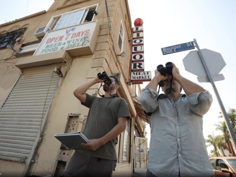 Christian Benitez and Eric M Wood stood outside a corner liquor store searching for birds. Genaro Melina, LA Times