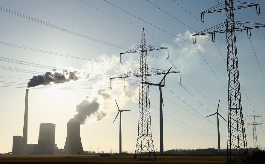 Electric distribution and generation in the foreground with natural gas infrastructure in the background.