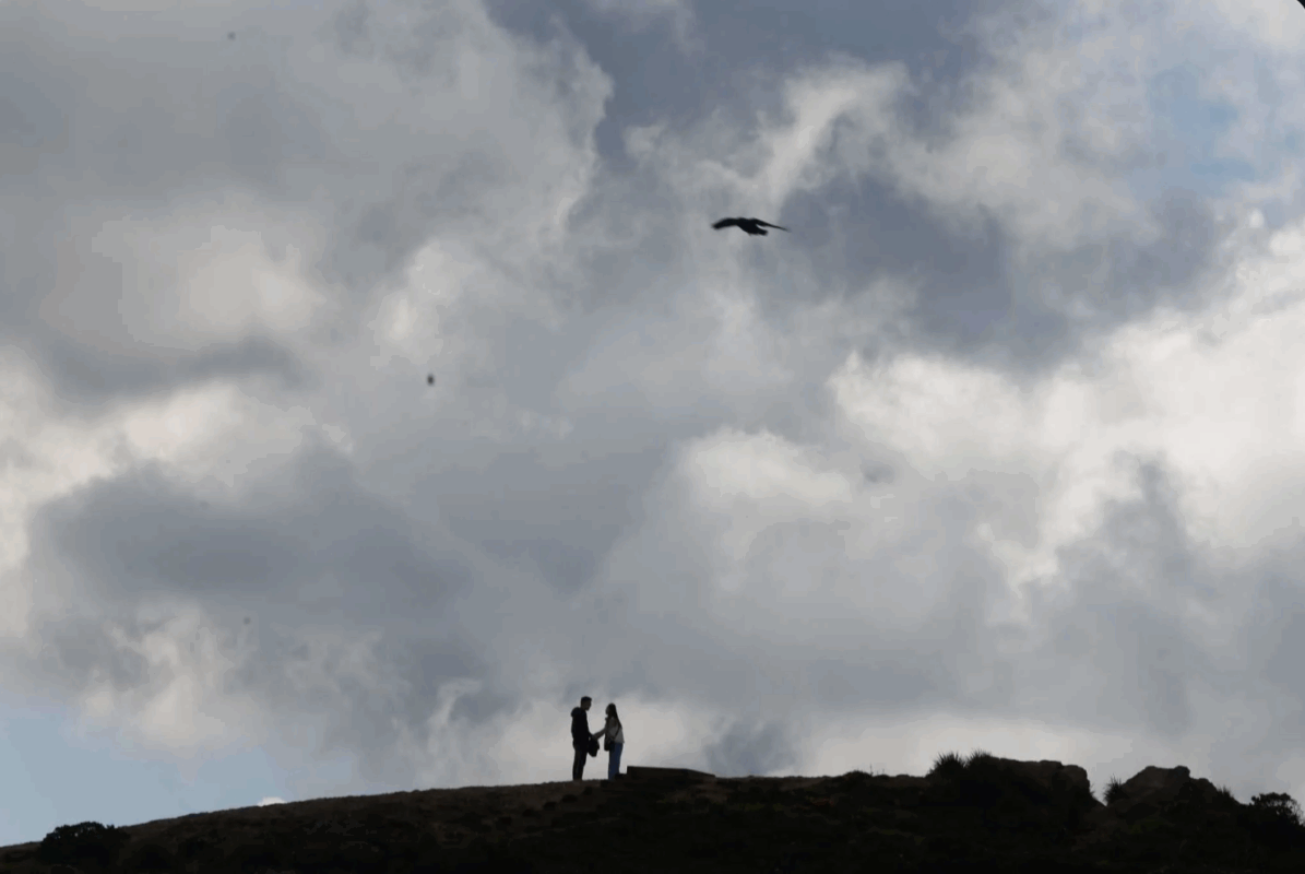 A couple are silhouetted under a cloudy peak as they hike at San Francisco’s Twin Peaks in March. Temperatures were below normal in California in 2023, thanks to an especially cold and wet winter. Lea Suzuki. The Chronicle 2023