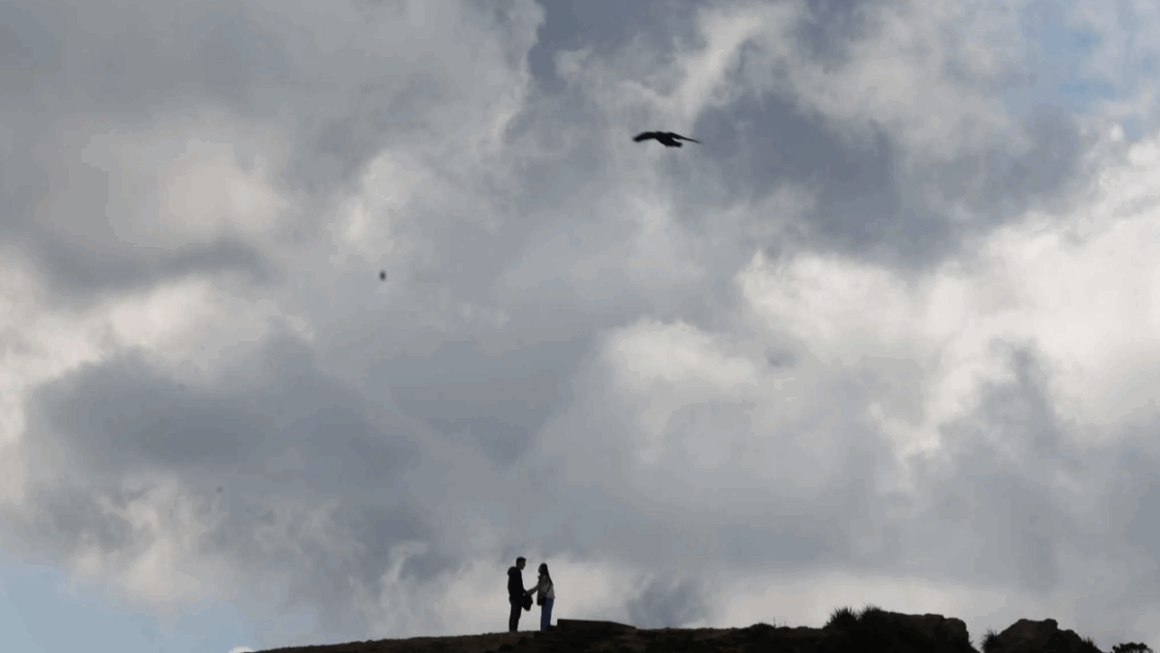 A couple are silhouetted under a cloudy peak as they hike at San Francisco’s Twin Peaks in March. Temperatures were below normal in California in 2023, thanks to an especially cold and wet winter. Lea Suzuki. The Chronicle 2023