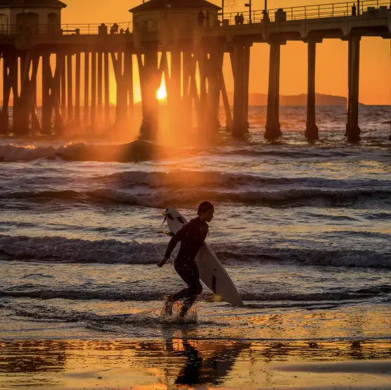 A surfer near Huntington Beach Pier in Huntington Beach on Monday.Credit...Leonard Ortiz/The Orange County Register, via Associated Press