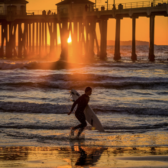 A surfer near Huntington Beach Pier in Huntington Beach on Monday.Credit...Leonard Ortiz/The Orange County Register, via Associated Press