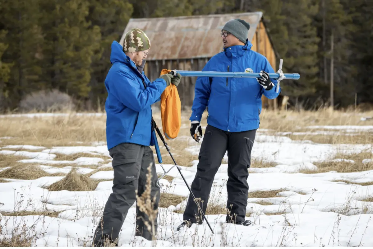 Right, Sean de Guzman and Anthony Burdock with the CA Department of Water Resources, measure snowpack during the first media snow survey of the 2024 season at Phillips Station in the Sierra Nevada. ( Xavier Mascareñas / California Department of Water Resources )