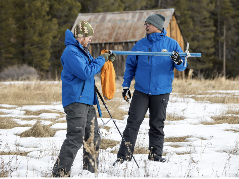 Right, Sean de Guzman and Anthony Burdock with the CA Department of Water Resources, measure snowpack during the first media snow survey of the 2024 season at Phillips Station in the Sierra Nevada. ( Xavier Mascareñas / California Department of Water Resources )