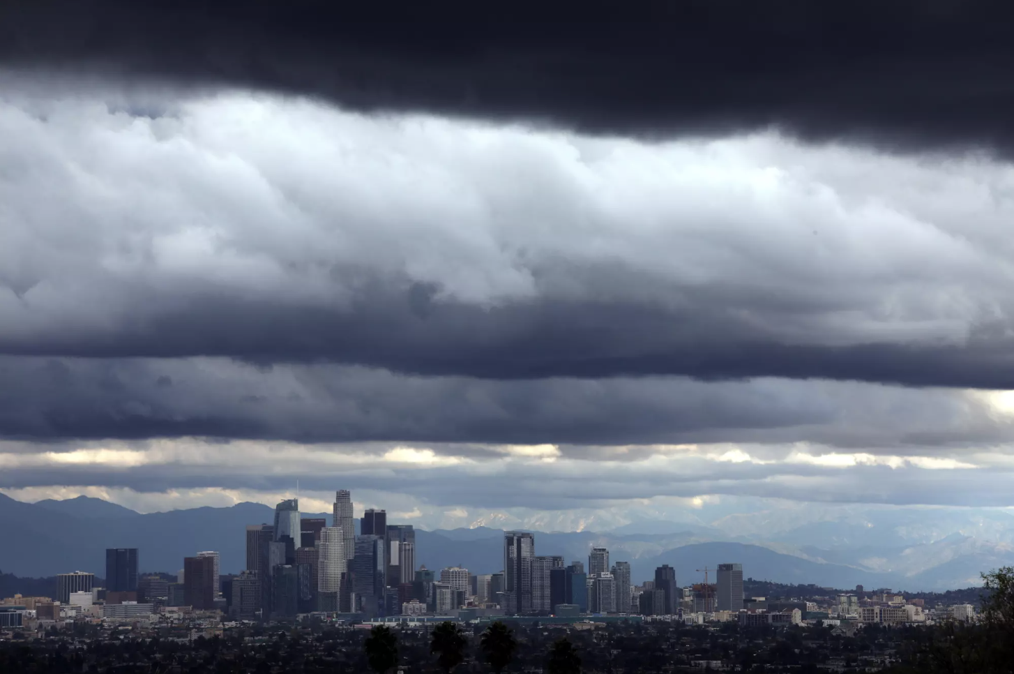 Despite a recent spate of storms that hit California, the Sierra Nevada is suffering a severe, early season ‘snow drought,’ experts say. Here, storm clouds dwarf downtown Los Angeles on Dec. 21, 2023. Credit Genaro Molina. Los Angeles Times