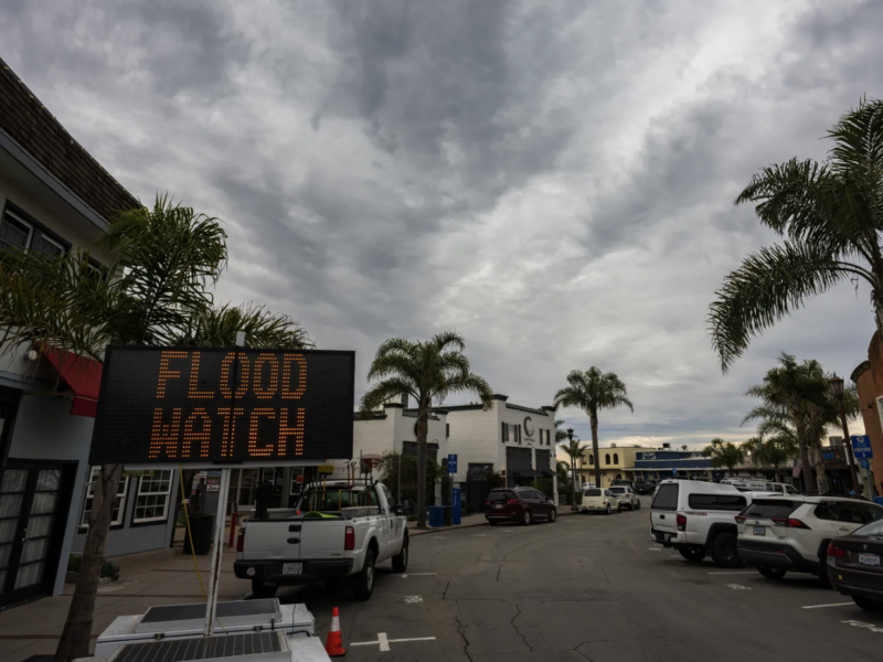 A sign warns of potential flooding in Capitola Village Wednesday, Jan. 31, 2024, in Capitola, Calif. An atmospheric river is set to make its way into Northern California, bringing warnings of heavy rain, possible flooding and high winds.(AP Photo/Nic Coury)