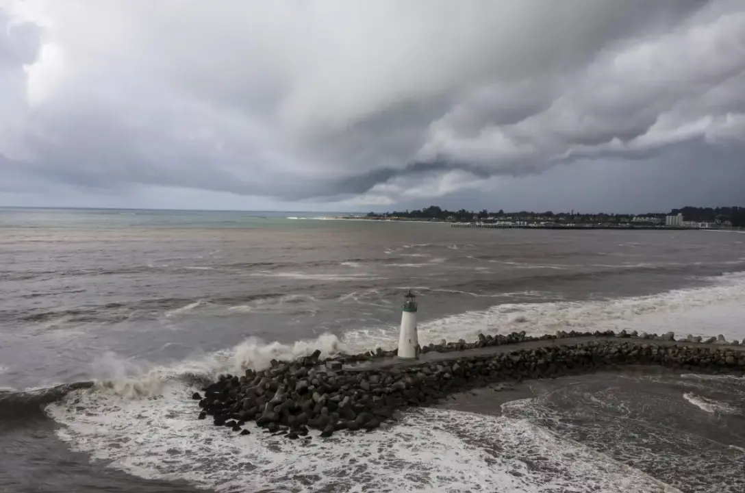 Storm clouds hang over Walton Lighthouse on Thursday in Santa Cruz The first of two back-to-back atmospheric rivers drenched California on Thursday