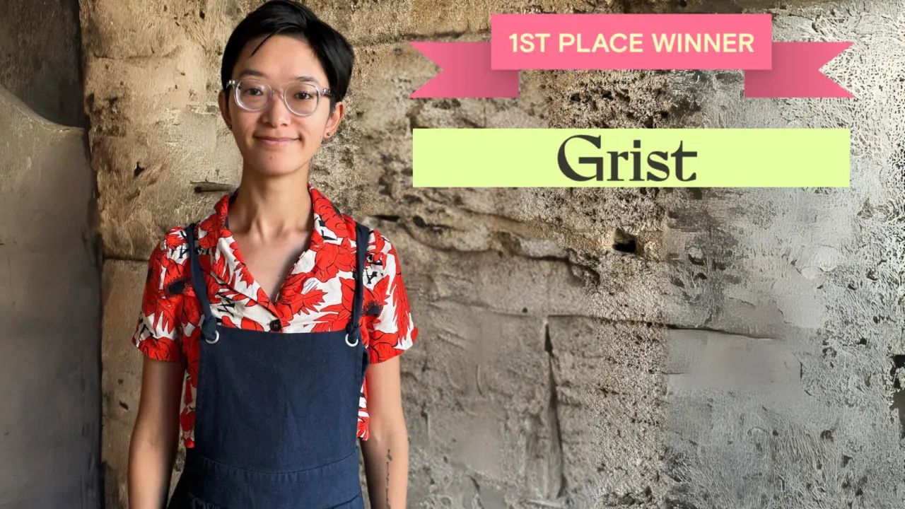 Jamie Liu stands against a stone wall beside a banner reading "1st Place Winner" and "Grist."
