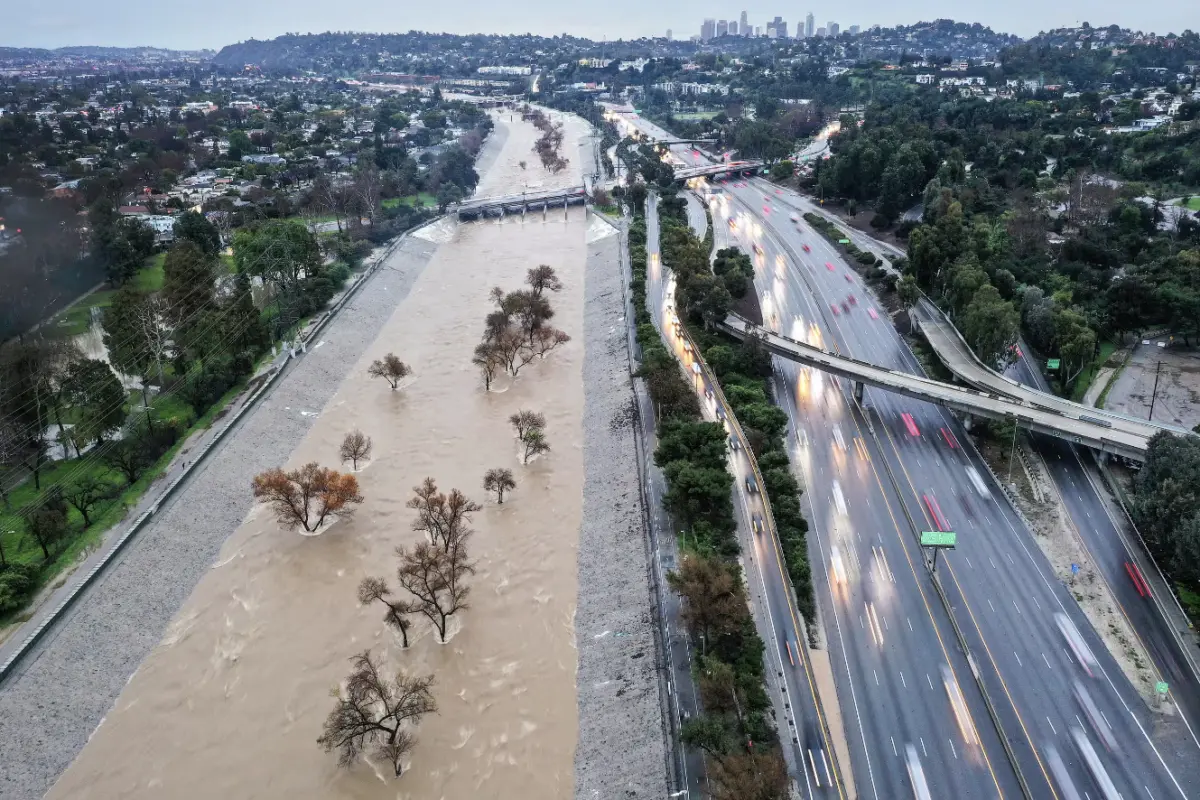 The Los Angeles River is swollen by storm runoff during an atmospheric river storm on Monday. Photograph: Mario Tama/Getty Images