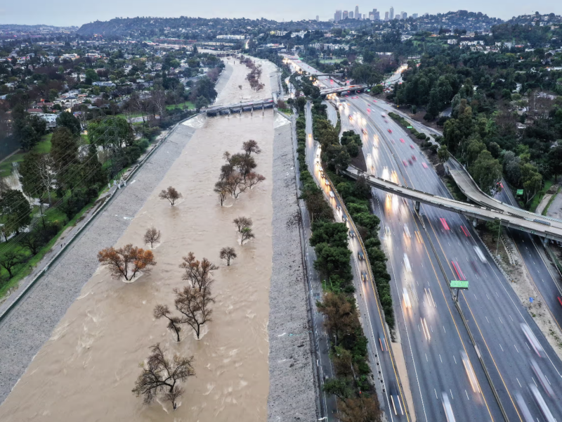 The Los Angeles River is swollen by storm runoff during an atmospheric river storm on Monday. Photograph: Mario Tama/Getty Images