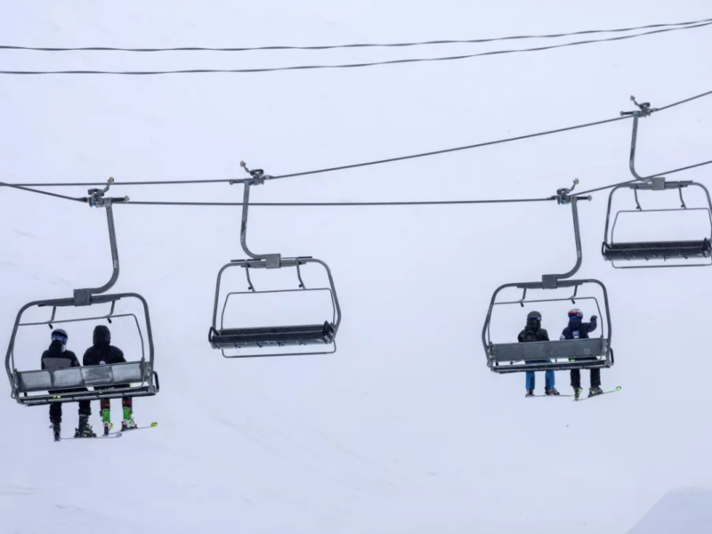 Skiers ride a chair lift on a blustery day at Mammoth Mountain on March 14 in Mammoth Lakes. (Brian van der Brug / Los Angeles Times)