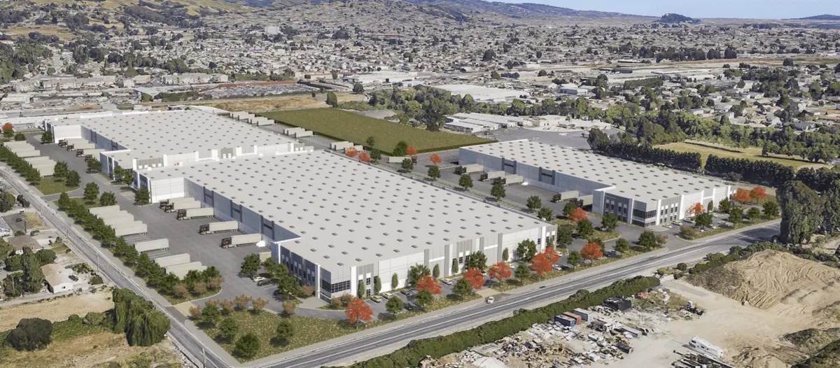 Aerial rendering of a large warehouse and logistics complex with loading docks and truck lots bordering a residential neighborhood.