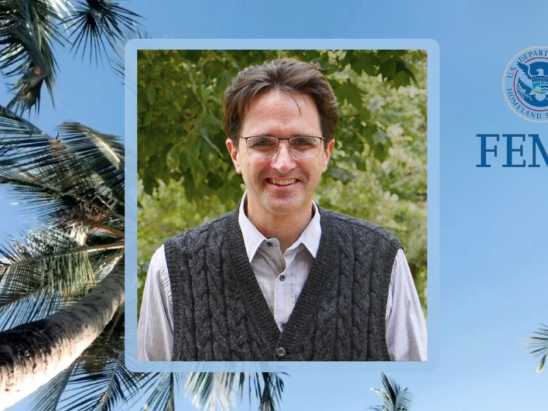 Photo of Travis Longcore with palm trees, blue sky, and FEMA logo in background.