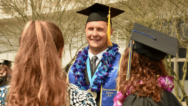 UCLA IoES graduate smiles after commencement ceremony