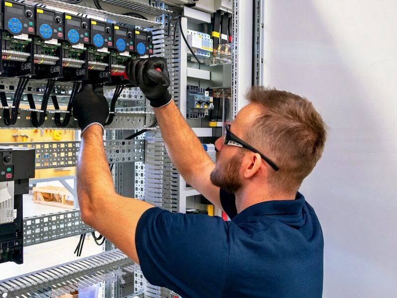 Electrician working on electric panel