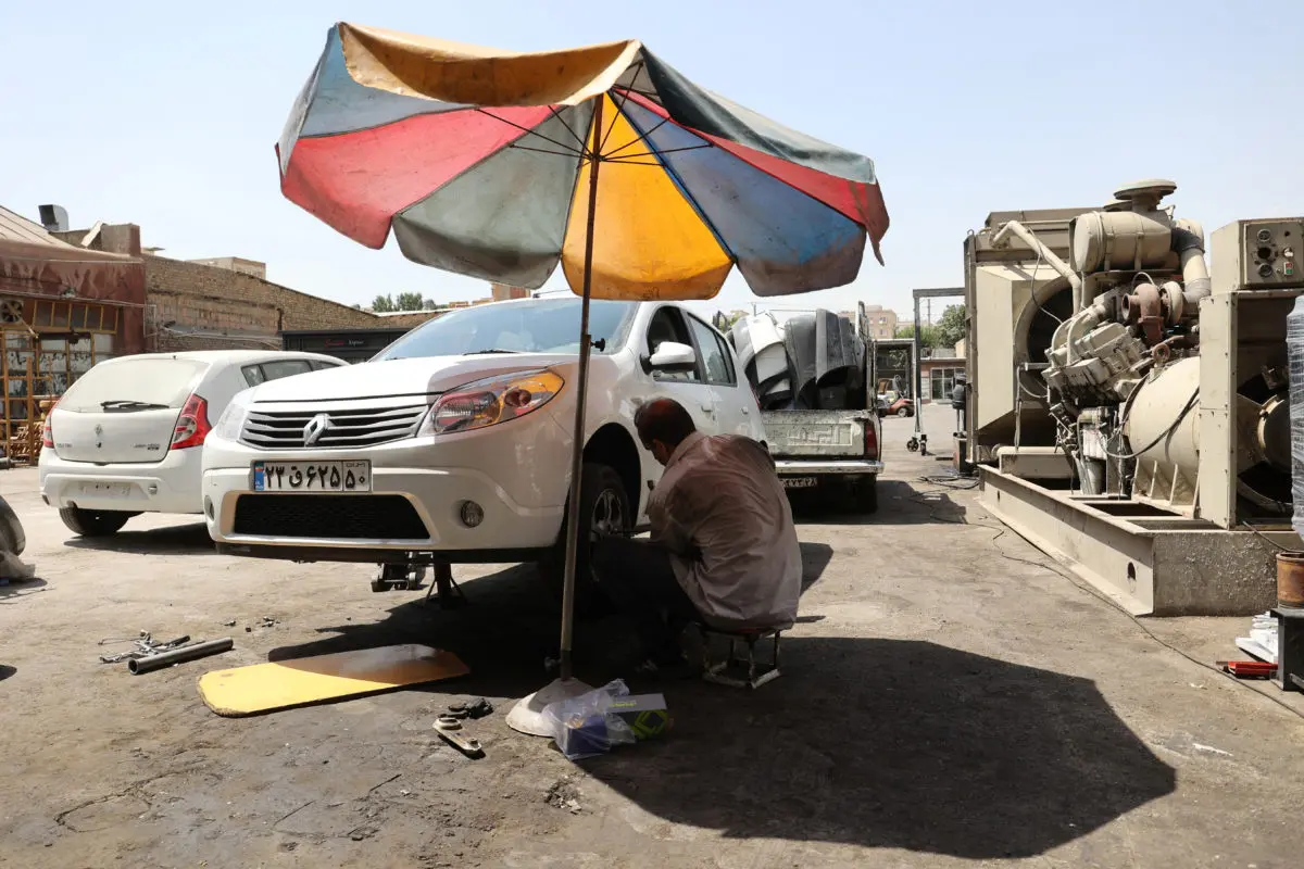 Iranian mechanic works during the heat surge in Tehran