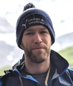 Ben Strong outdoors in a mountainous landscape.