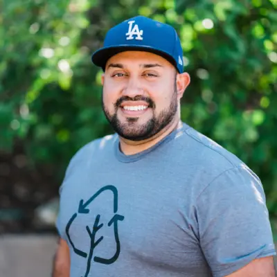 Michael Martinez, outdoors in front of greenery
