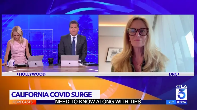 KTLA news anchors interview Dr. Anne Rimoin by video link under a chyron reading "California Covid surge."