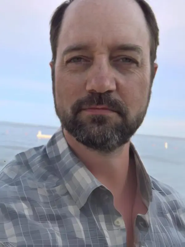 Erik Hoffner, with the ocean and sky behind him