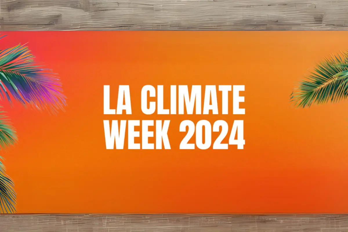 "LA Climate Week 2024" in white text on an orange banner framed by palm fronds against a wood background.