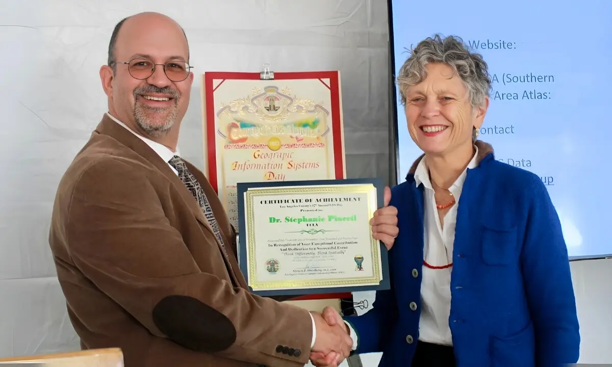 Caption: Steven Steinberg, L.A. County’s Geographic Information Officer, presents Pincetl with an award at the county’s 17th annual GIS Day