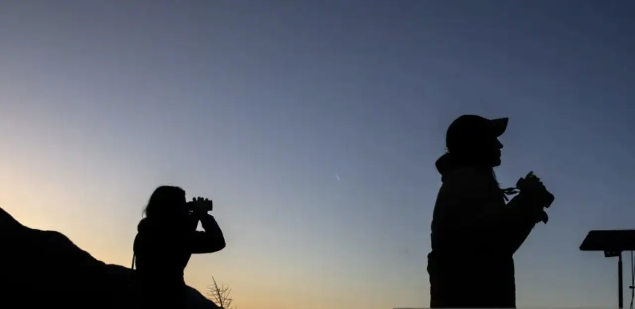 Birders looking through binoculars.