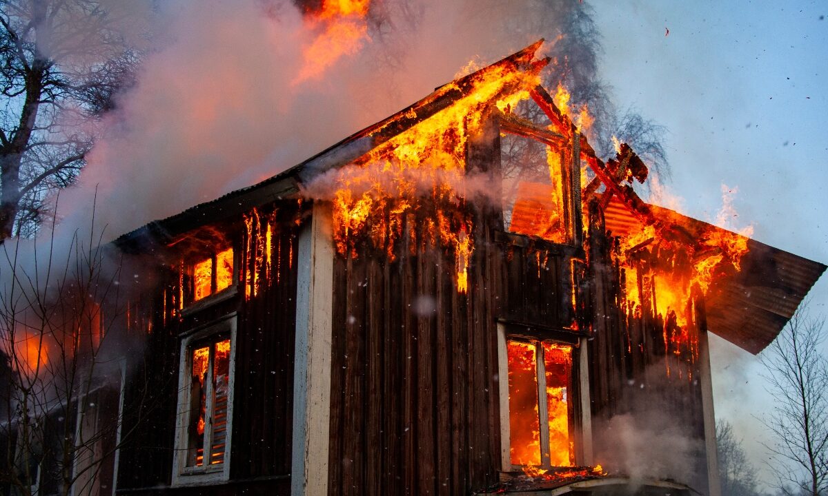 Old wooden house on fire by Mattias Bokinge, Canva