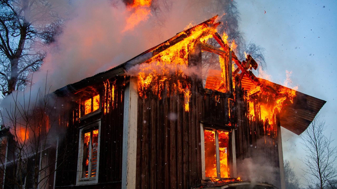 Old wooden house on fire by Mattias Bokinge, Canva