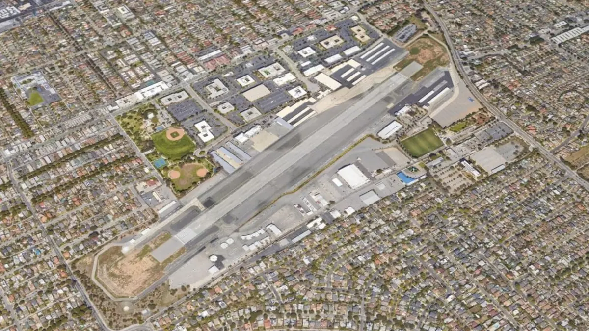Aerial view of Santa Monica Airport's single runway and hangars surrounded by dense residential neighborhoods.