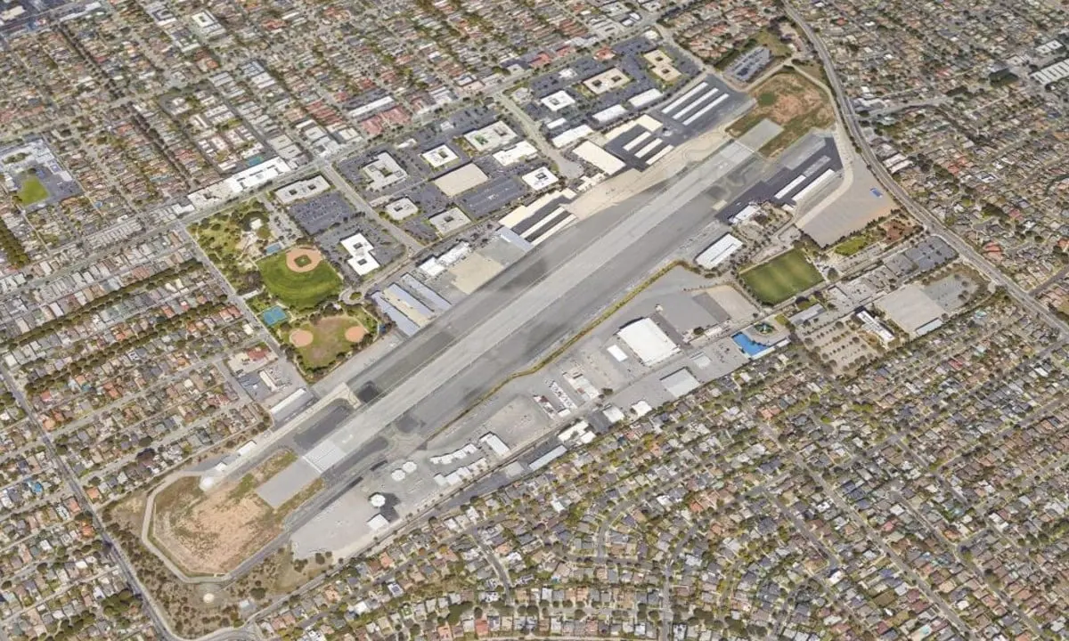Aerial view of Santa Monica Airport's single runway and hangars surrounded by dense residential neighborhoods.