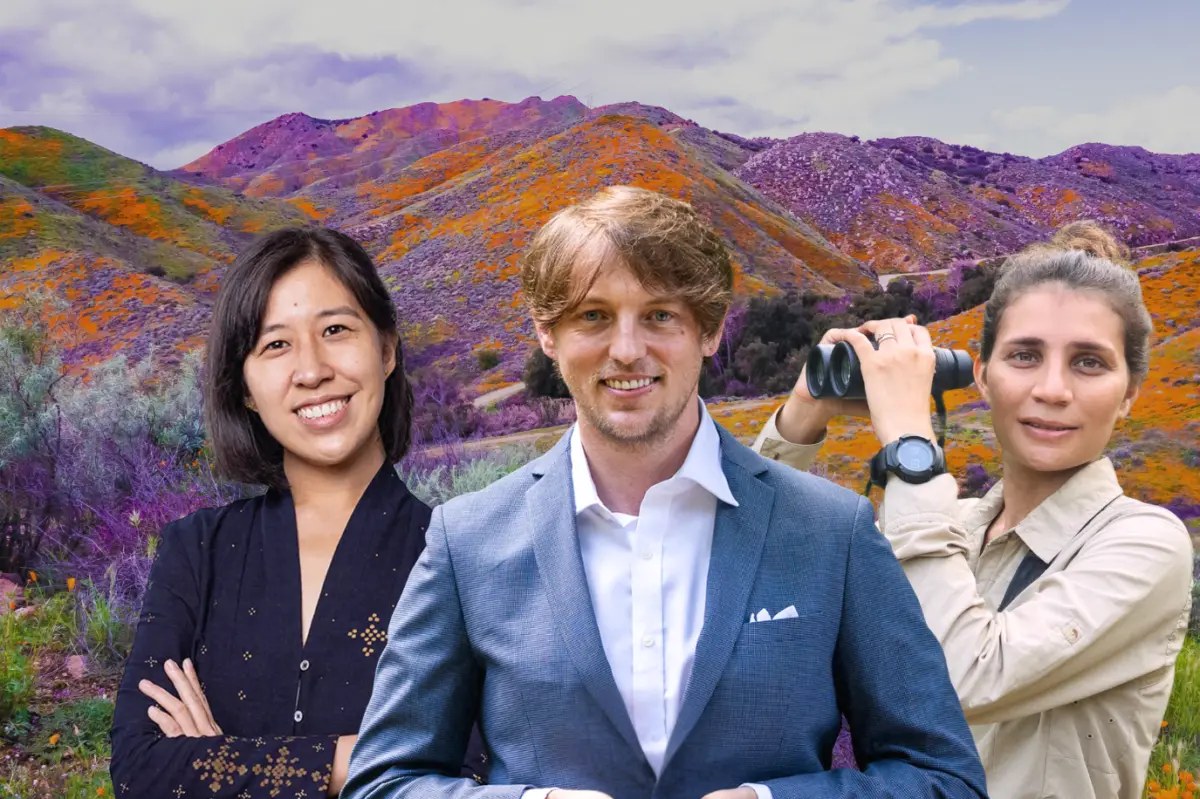 The 2025 Pritzker Emerging Environmental Genius Finalists, from left to right: Denica Riadini-Flesch, Anthony Waddle, and Seema Lokhandwala, stand in front of a colorful, vibrant landscape of purple, orange and green flowers under neath a light blue and white sky.