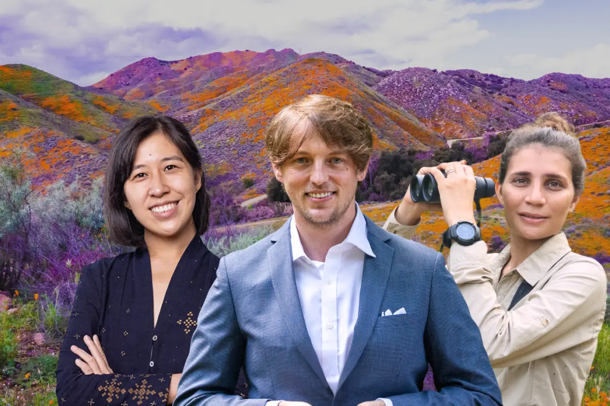 The 2025 Pritzker Emerging Environmental Genius Finalists, from left to right: Denica Riadini-Flesch, Anthony Waddle, and Seema Lokhandwala, stand in front of a colorful, vibrant landscape of purple, orange and green flowers under neath a light blue and white sky.