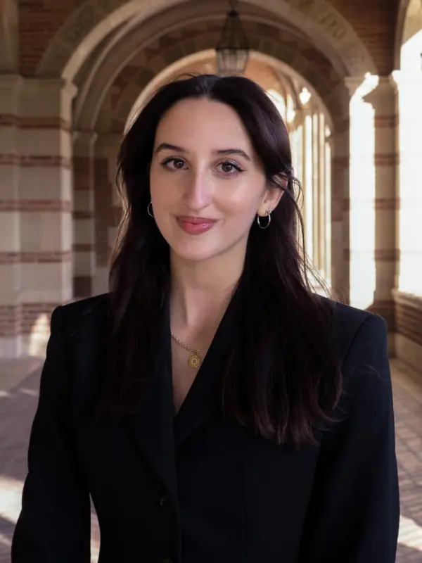 Ria Mehra, photographed in a brick archway walkway on the UCLA campus.