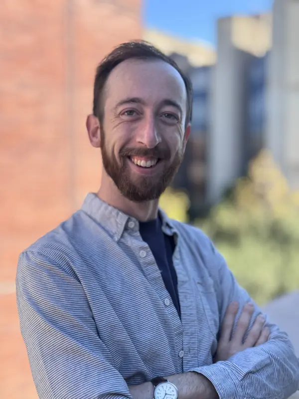 Jackson Guzé, photographed outdoors near a campus building.
