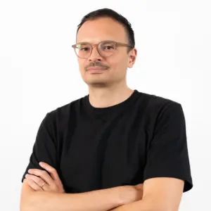 Salmaan Craig arms crossed against white background