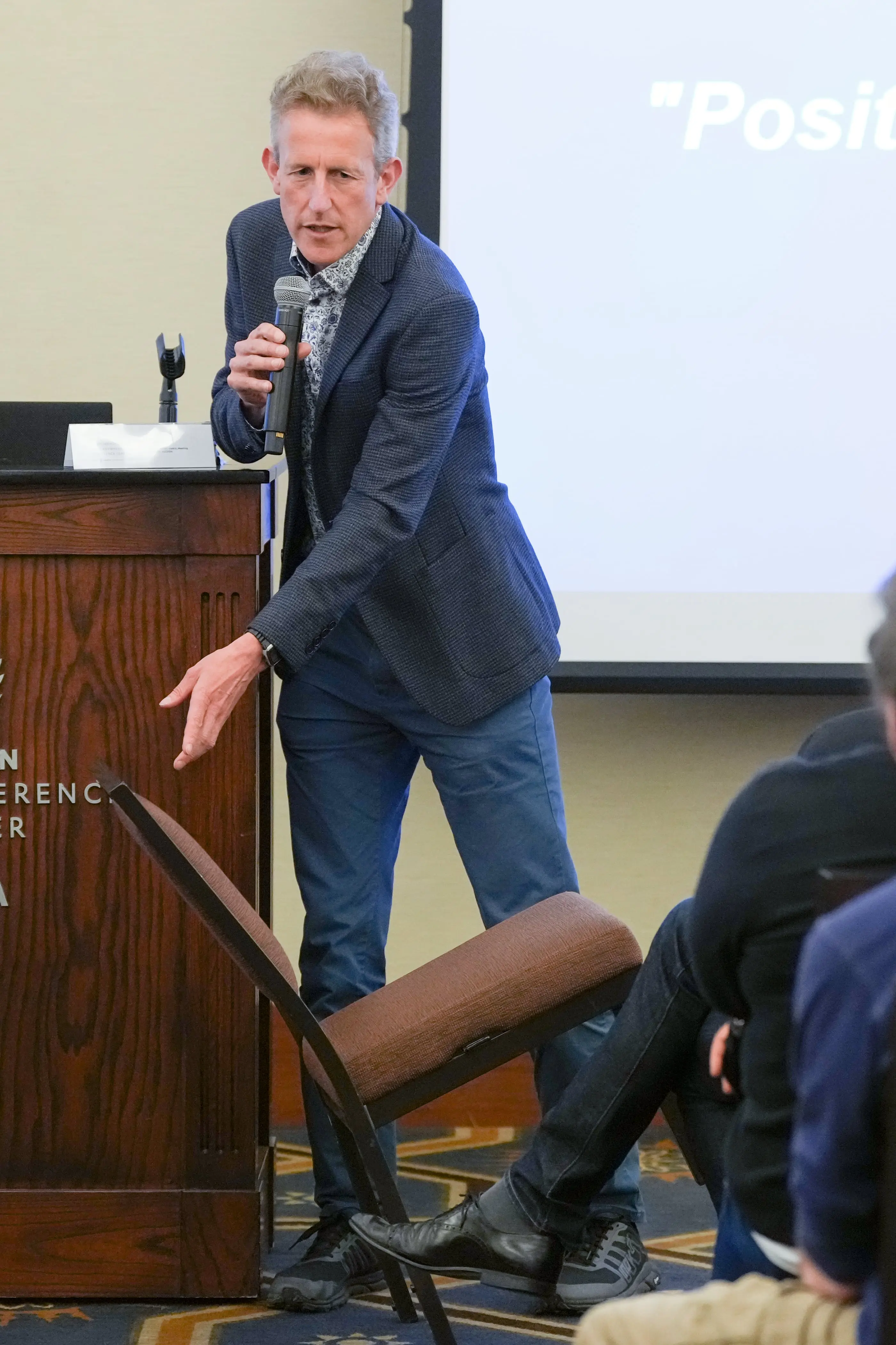 Professor Tim Lenton demonstrating the tipping chair analogy. 